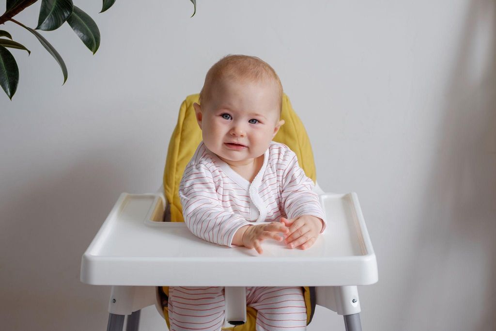 Baby high chairs displayed in a showroom, highlighting adjustable and ergonomic features.