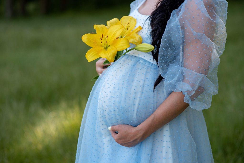 Pregnant woman in beautiful blue dress.