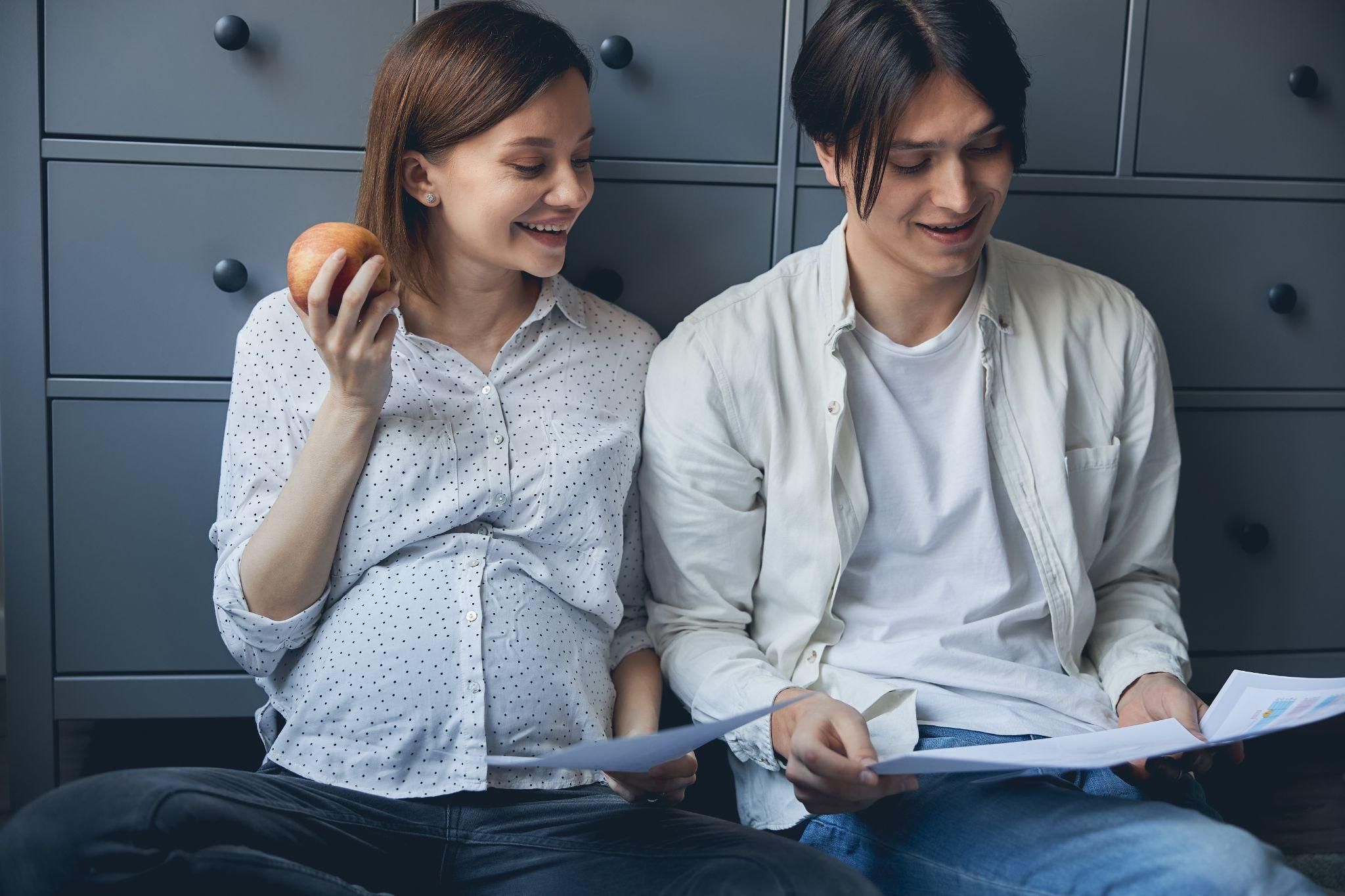 Parents-to-be reviewing finances and a baby checklist.