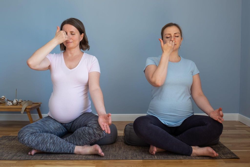 Serene pregnant women focusing on antenatal breathing exercises.