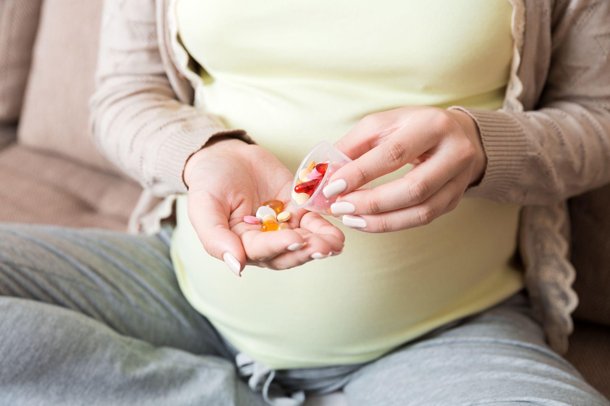 A pregnant woman consulting her doctor about anti-sickness medication options.