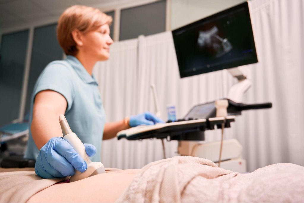 A pregnant woman getting an ultrasound scan to check her amniotic fluid levels.