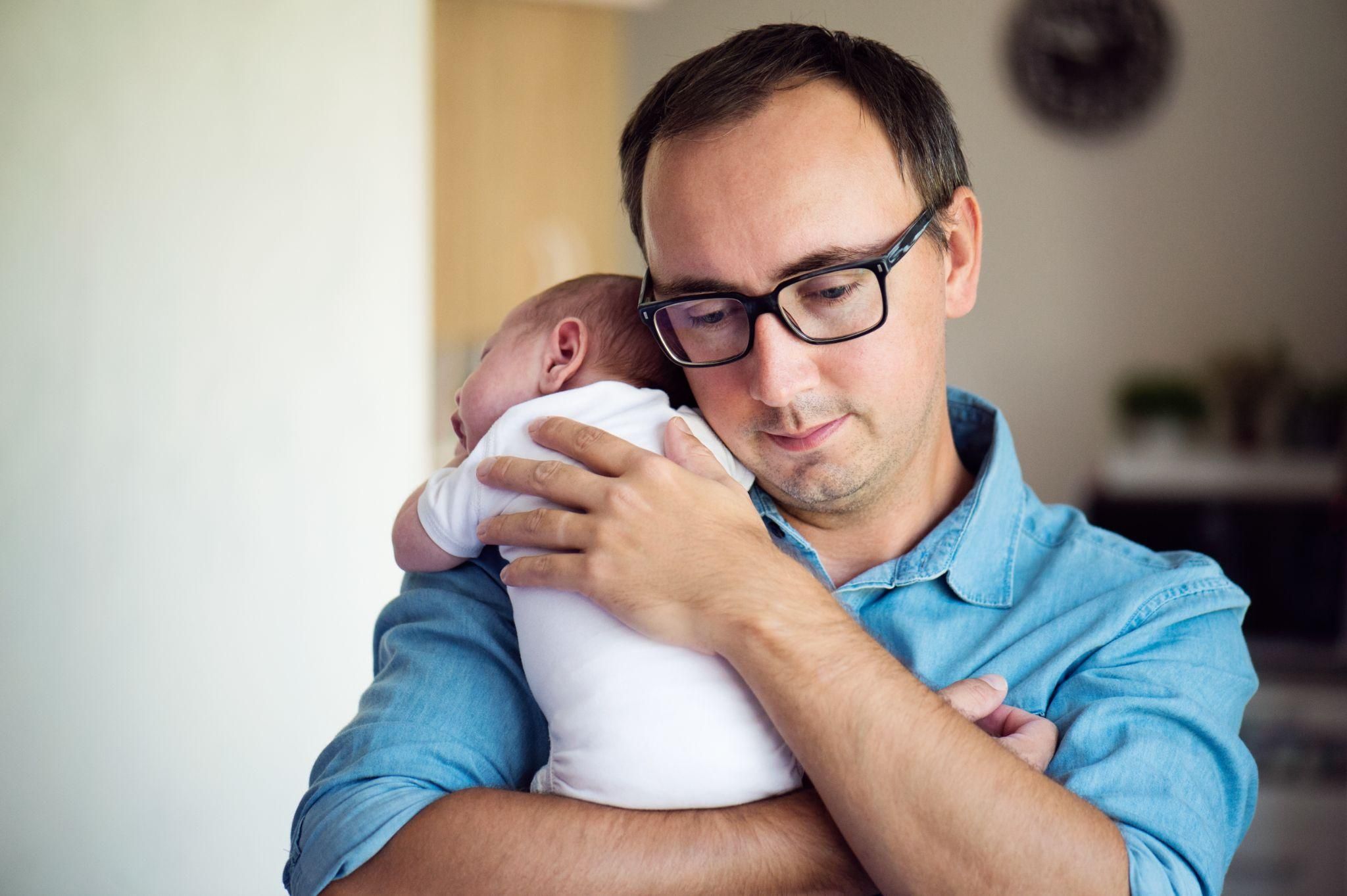 A father helping his partner during postpartum by managing baby care and household tasks.