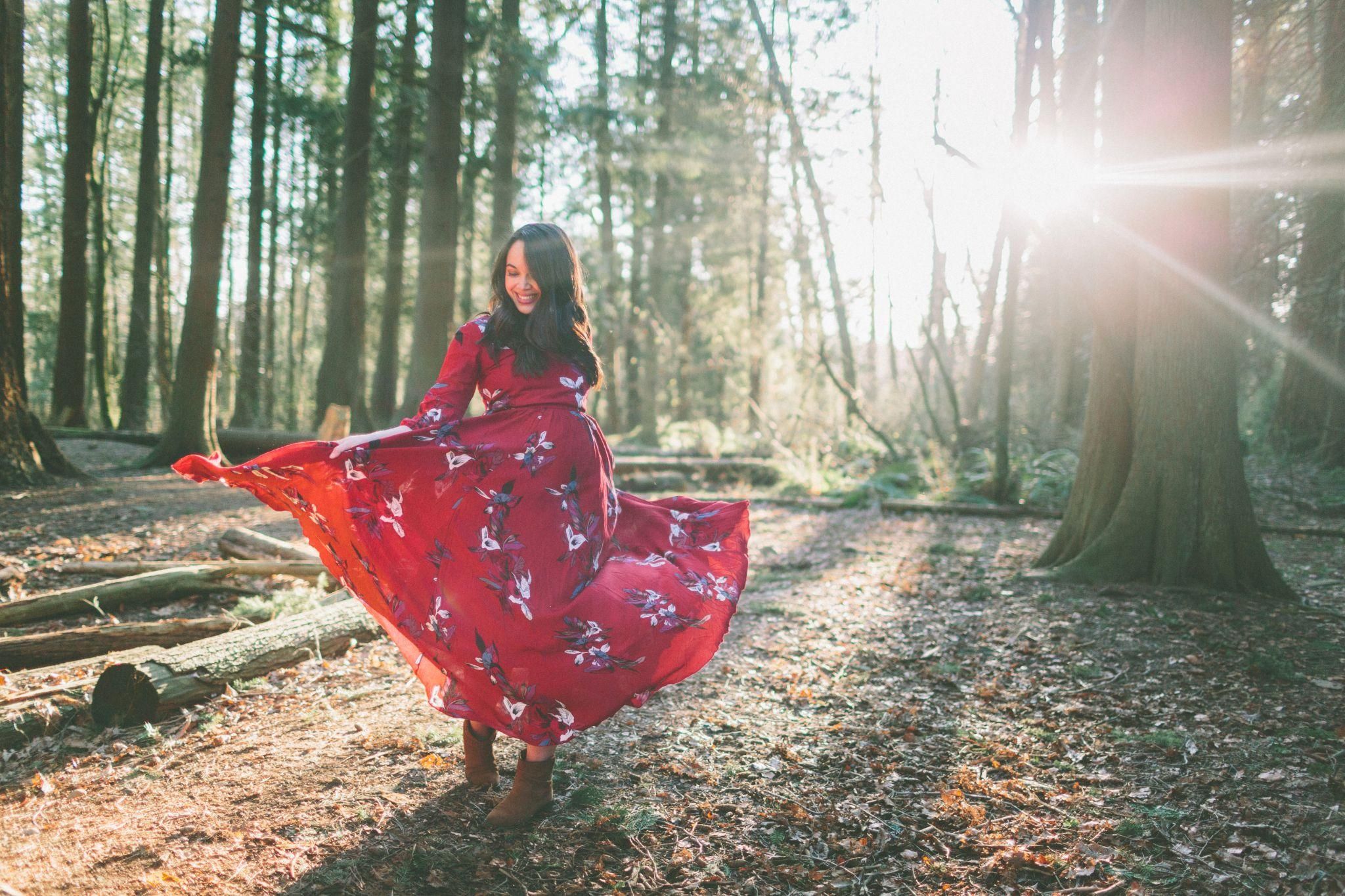 Pregnant woman posing outdoors during golden hour, symbolising the beauty and strength of pregnancy.