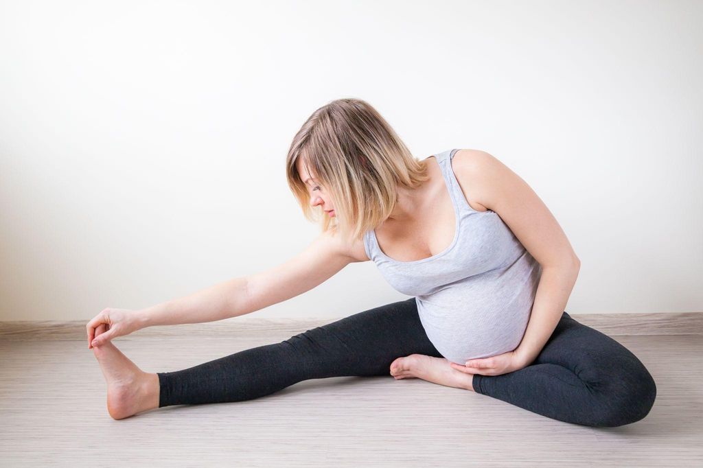 A pregnant woman practising yoga during pregnancy to prepare for labour.