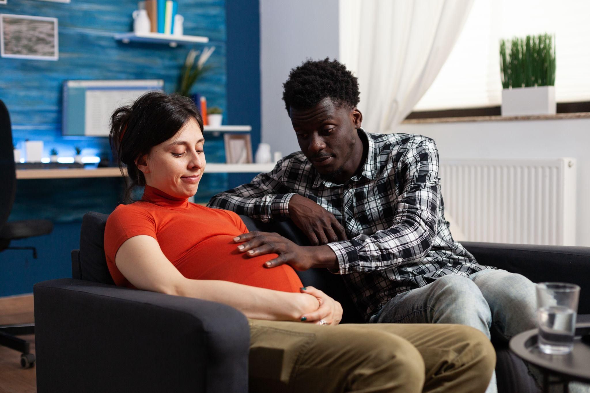 New parents discussing household responsibilities with their baby.