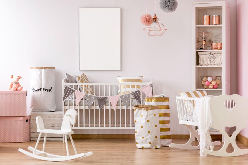 A beautifully designed nursery with essential furniture such as a cot, rocking chair, and changing table.