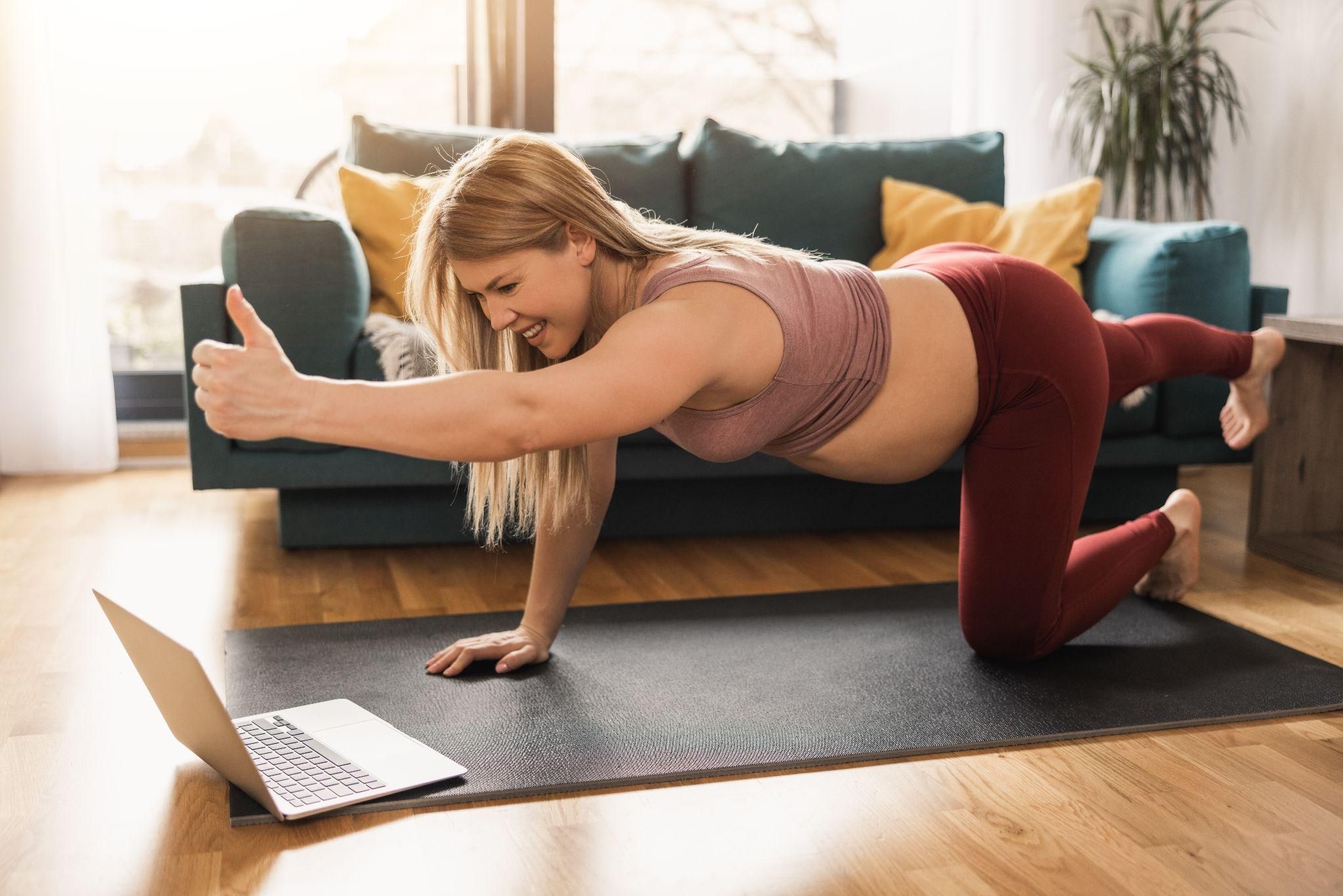 A group of postpartum women practicing yoga for body positivity and acceptance.