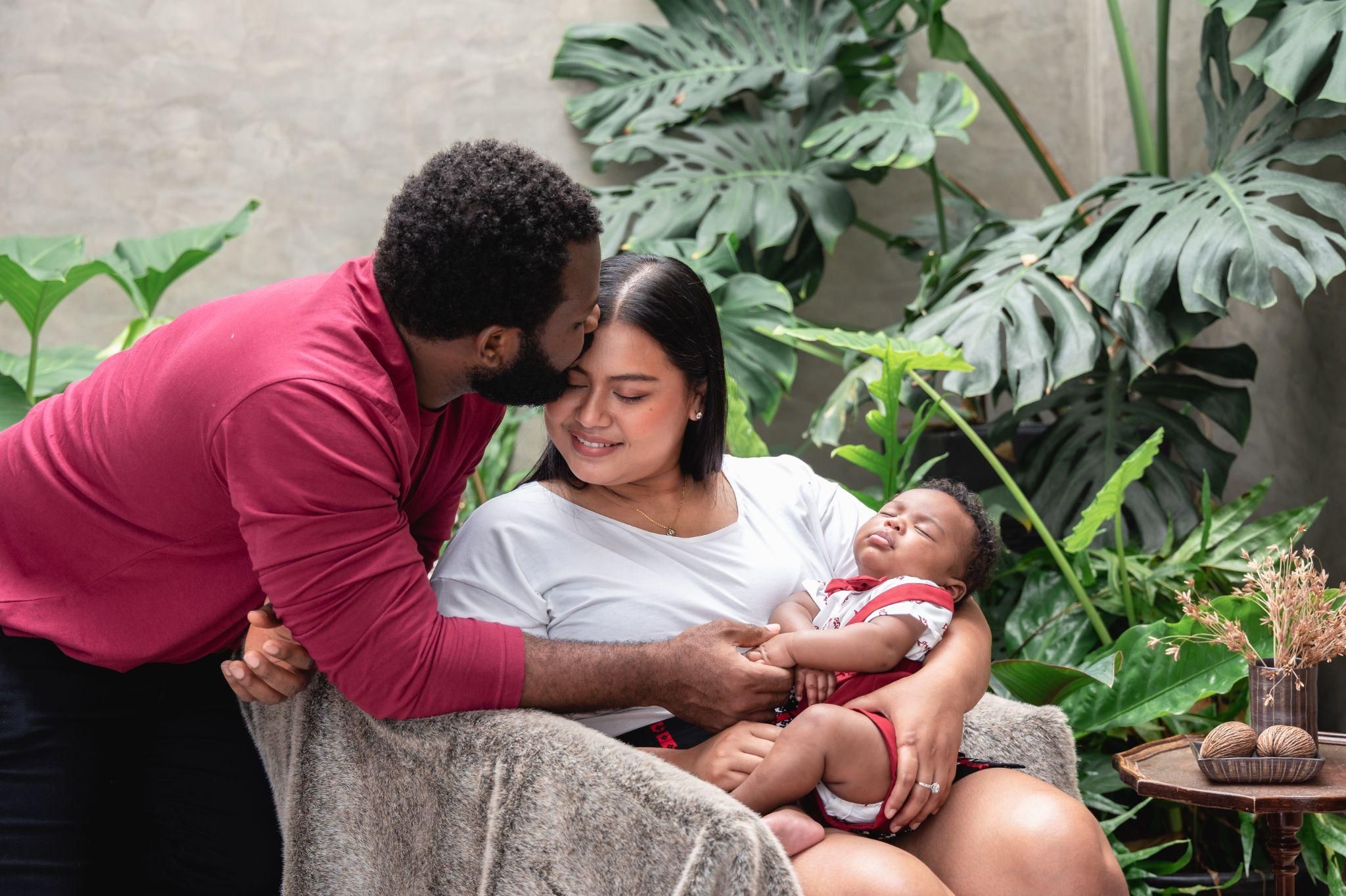 New parents in hospital room with newborn baby, supporting recovery and bonding