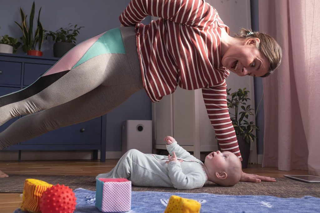 A new mother doing gentle postpartum core exercises at home.