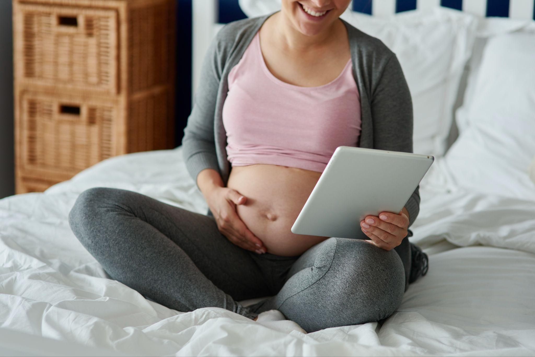 A happy mother embracing her postpartum journey with My Expert Midwife.