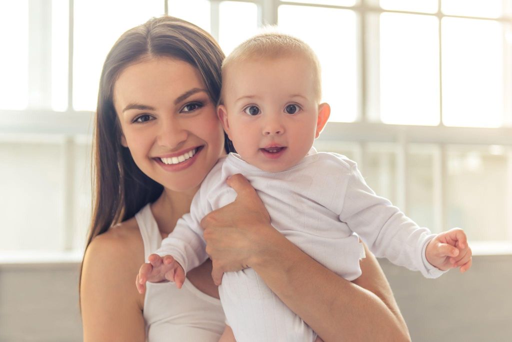 A new mother smiles with her baby.