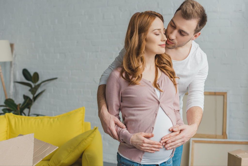 A couple embracing during pregnancy, symbolising trust and intimacy.