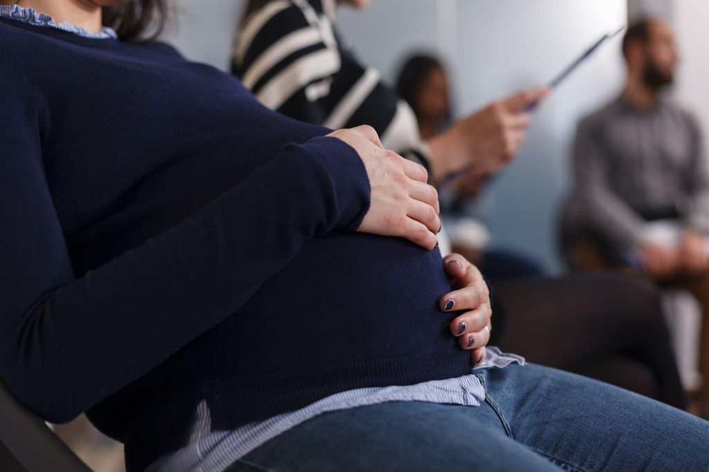 Husband supporting wife during the third trimester, attending antenatal classes together.