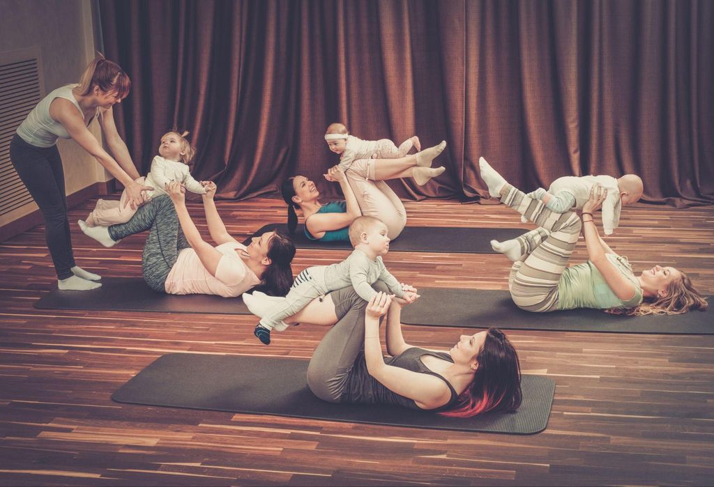 Hailey Bieber practising postnatal yoga in a serene home setting, radiating calm and wellness.