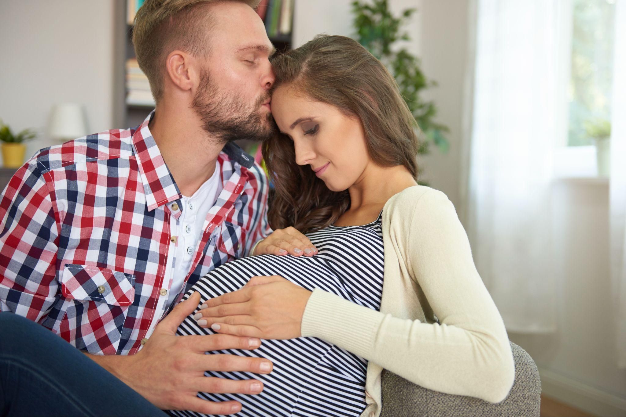 A mother bonding with her newborn right after childbirth, assisted by healthcare professionals.