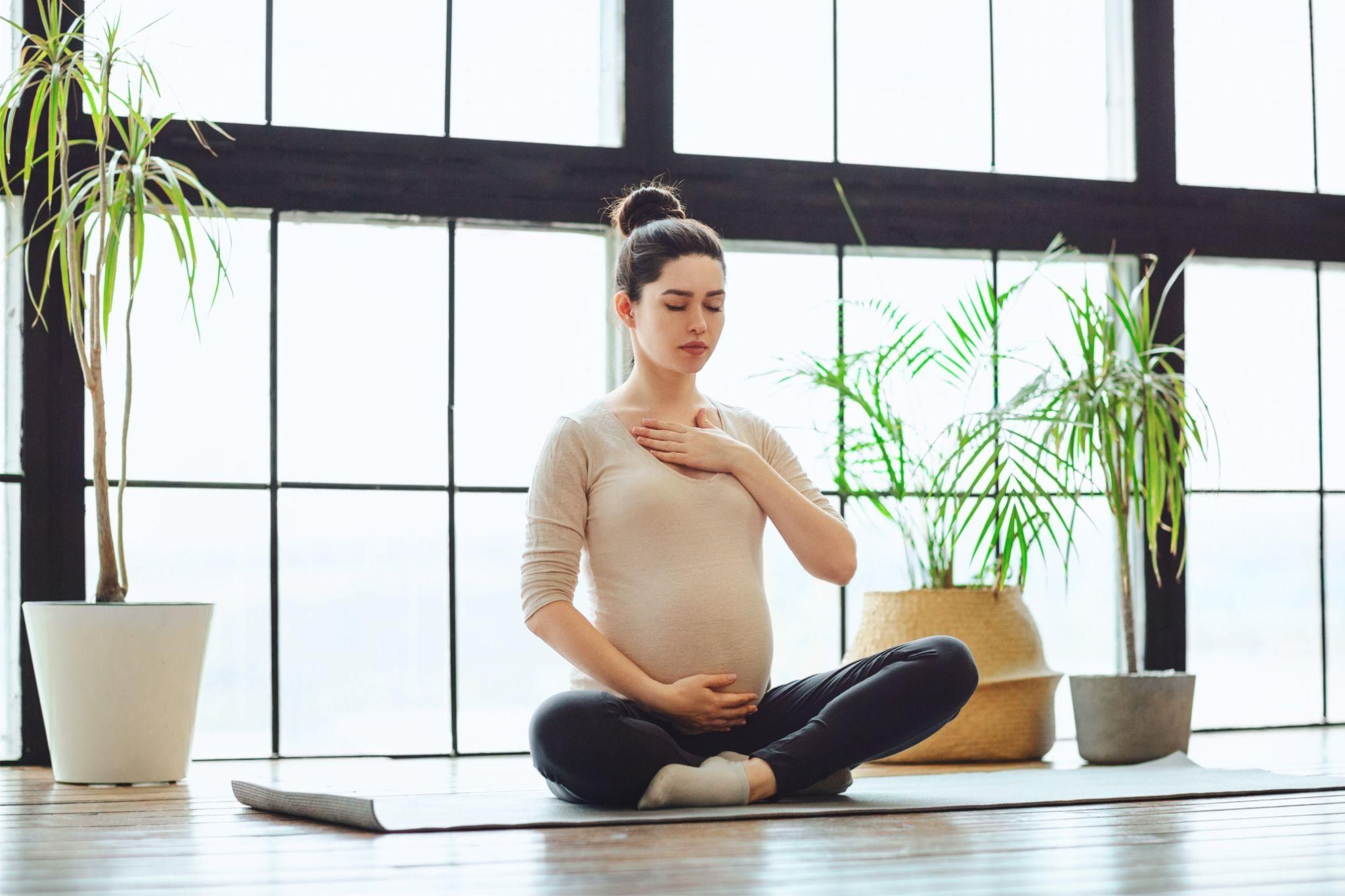 Pregnant woman participating in an antenatal yoga session.