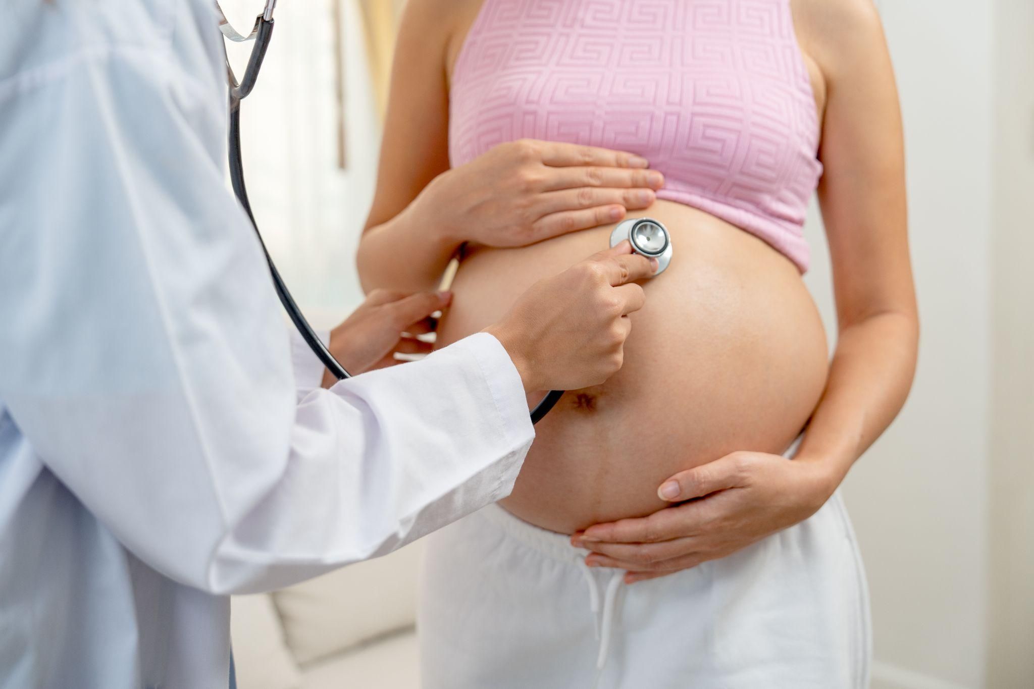 A healthcare professional administering antenatal steroids to a pregnant woman at risk of preterm birth.