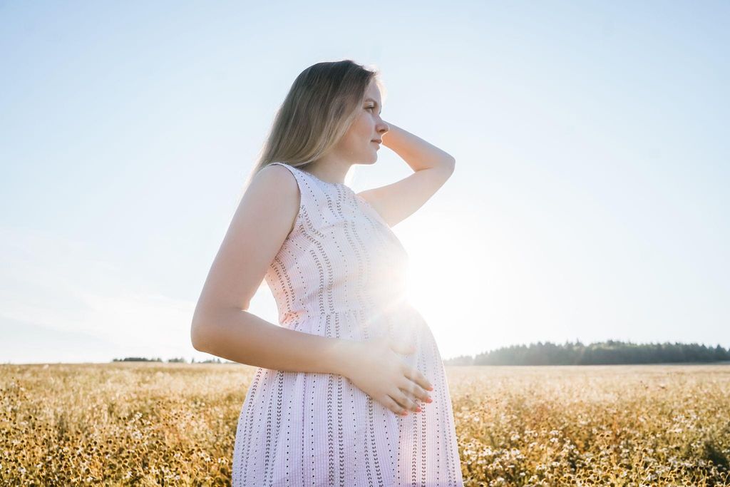 A worried pregnant woman contemplating her future bond with her baby.