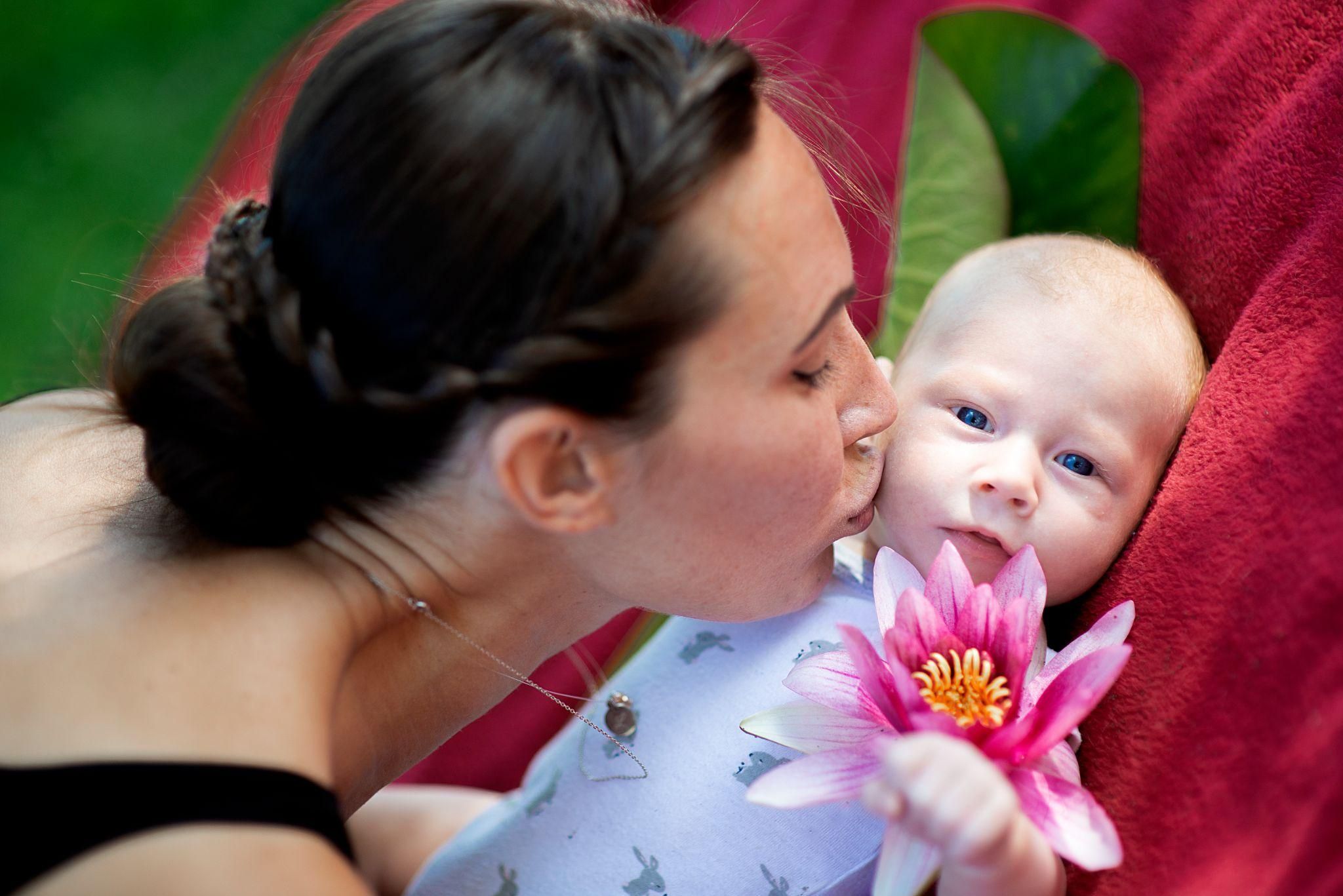 Mother and baby with the placenta still attached after birth, a lotus birth practice.