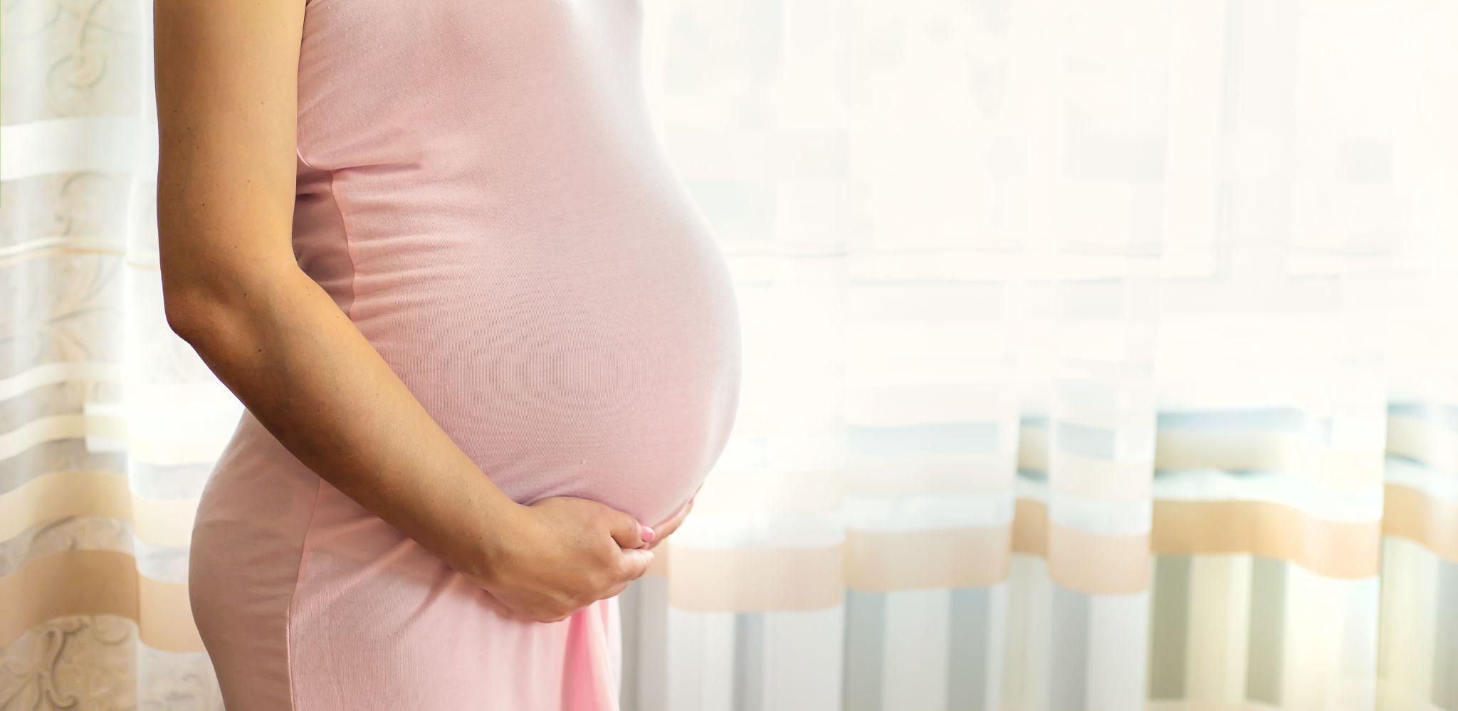 Pregnant woman practising prenatal yoga to manage shortness of breath during the third trimester.