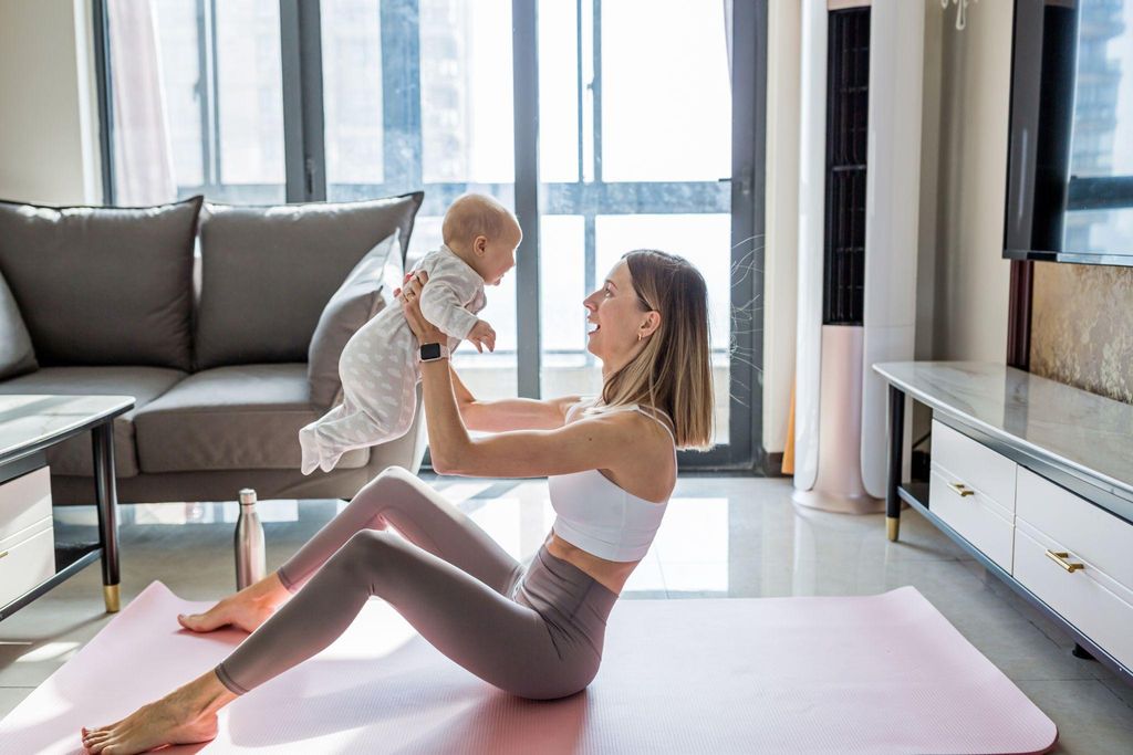 New mother practicing yoga post-pregnancy for recovery and well-being.