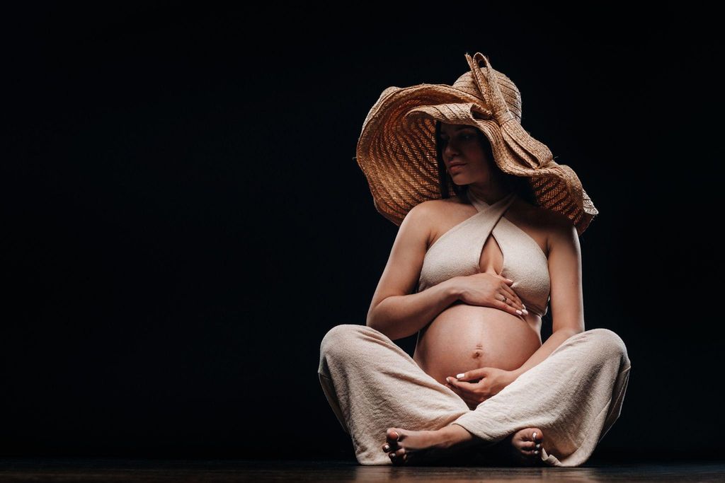 A serene pregnant woman practicing yoga, emphasising balance and self-care during pregnancy.