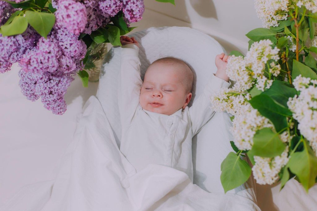 Hailey Bieber holding her newborn baby Jack, smiling alongside Justin Bieber.