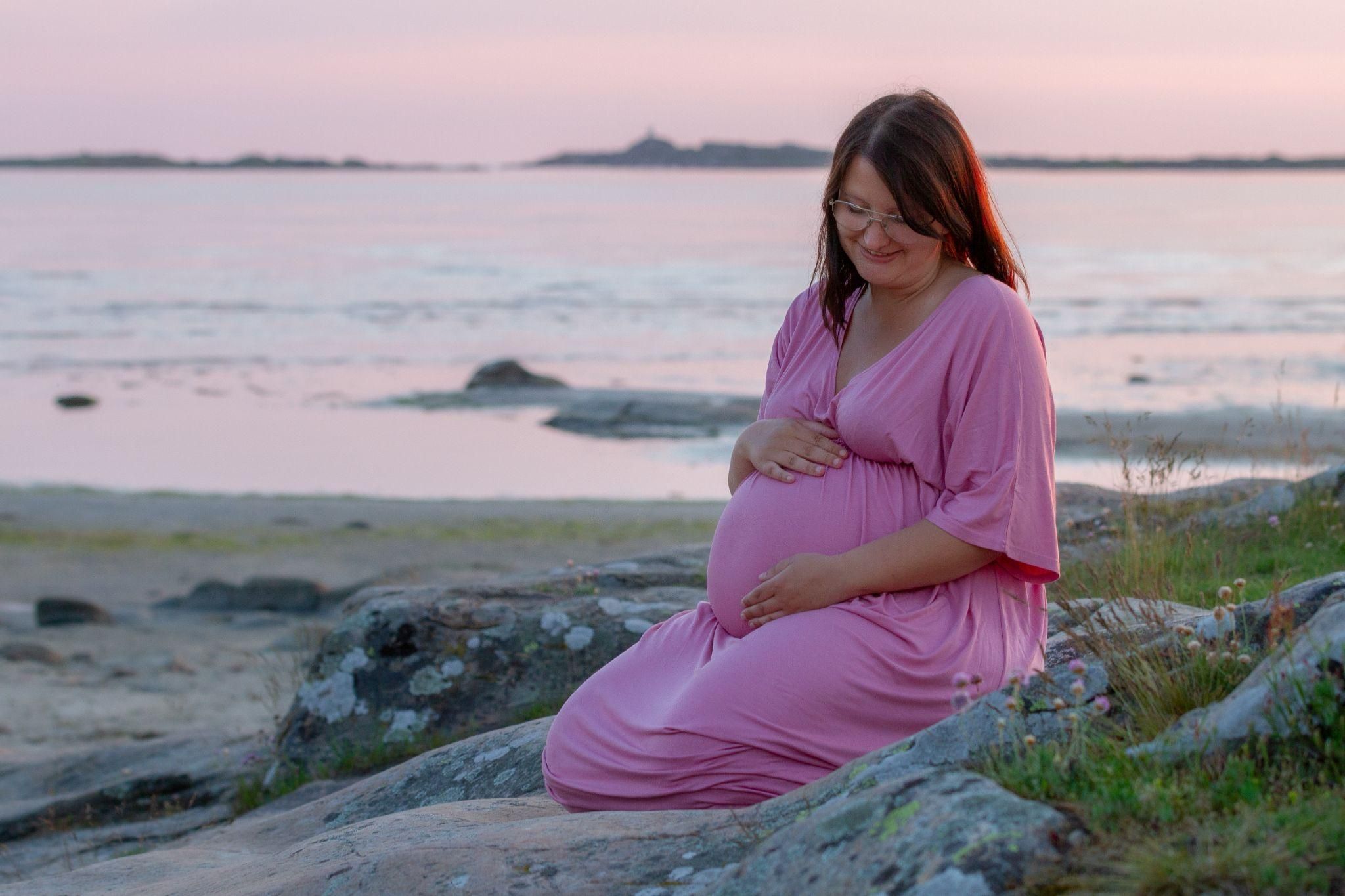 A pregnant woman in Child’s Pose, practising antenatal yoga for cramp relief.