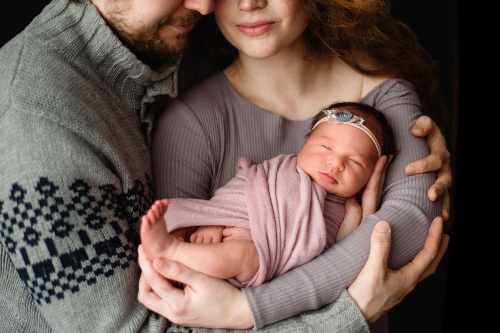 A new mother peacefully holding her baby during the postpartum recovery period, reflecting on physical and emotional healing.