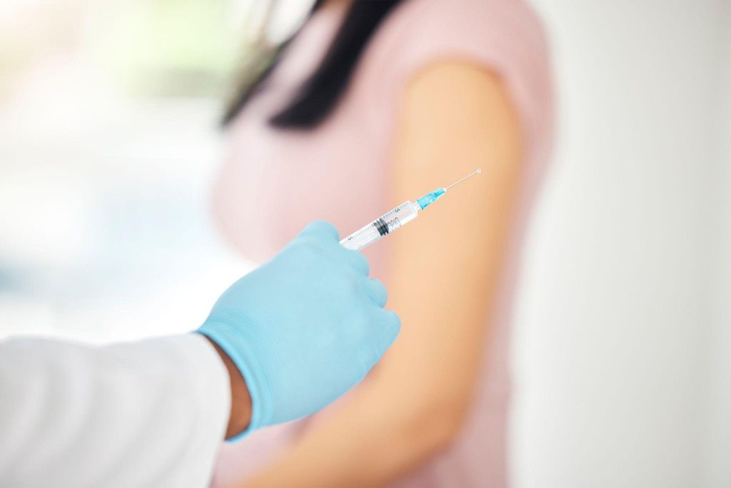 A pregnant woman receiving the 3-in-1 vaccine at an antenatal clinic.