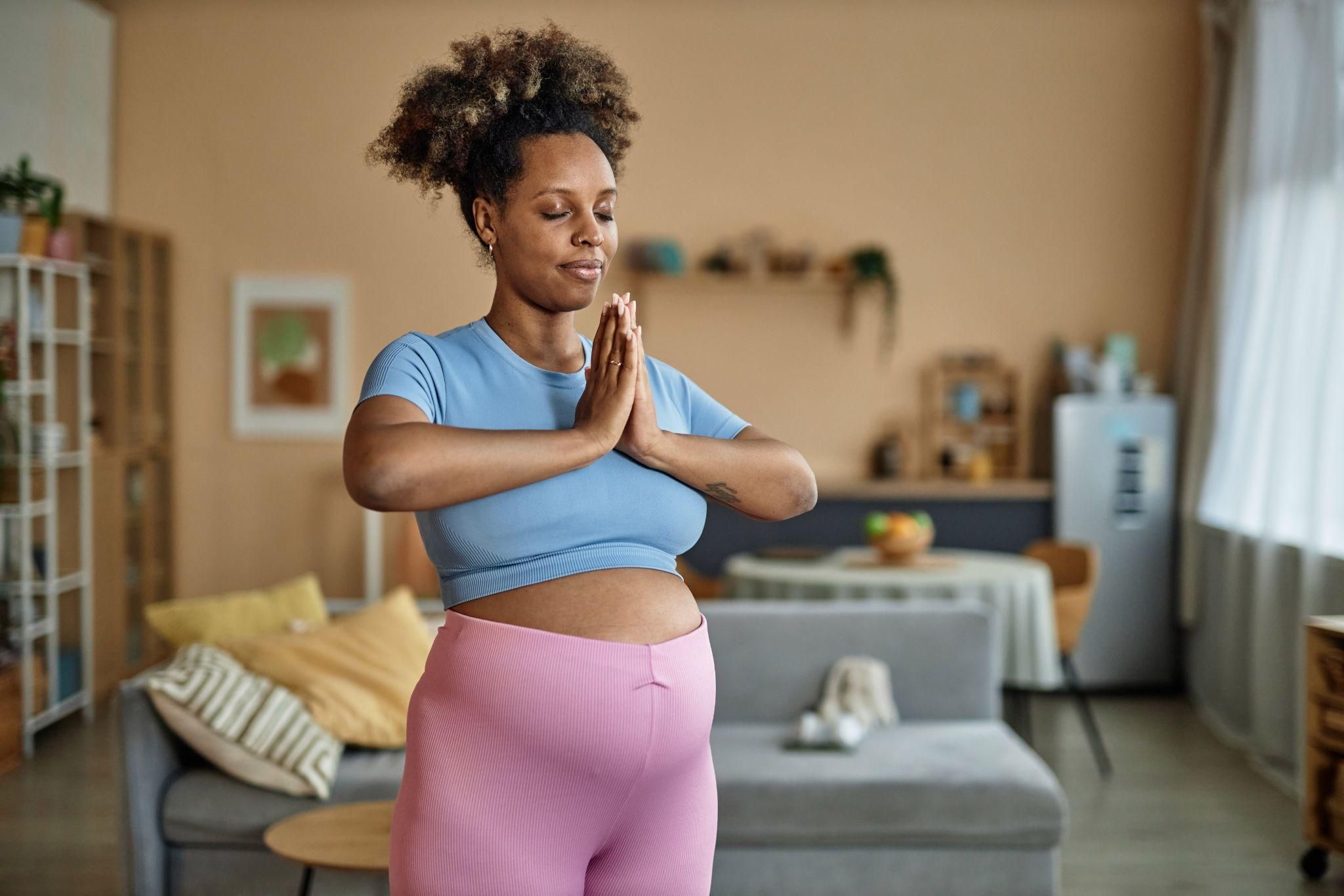 A pregnant woman practising antenatal yoga as part of her preparation for becoming an older mum.