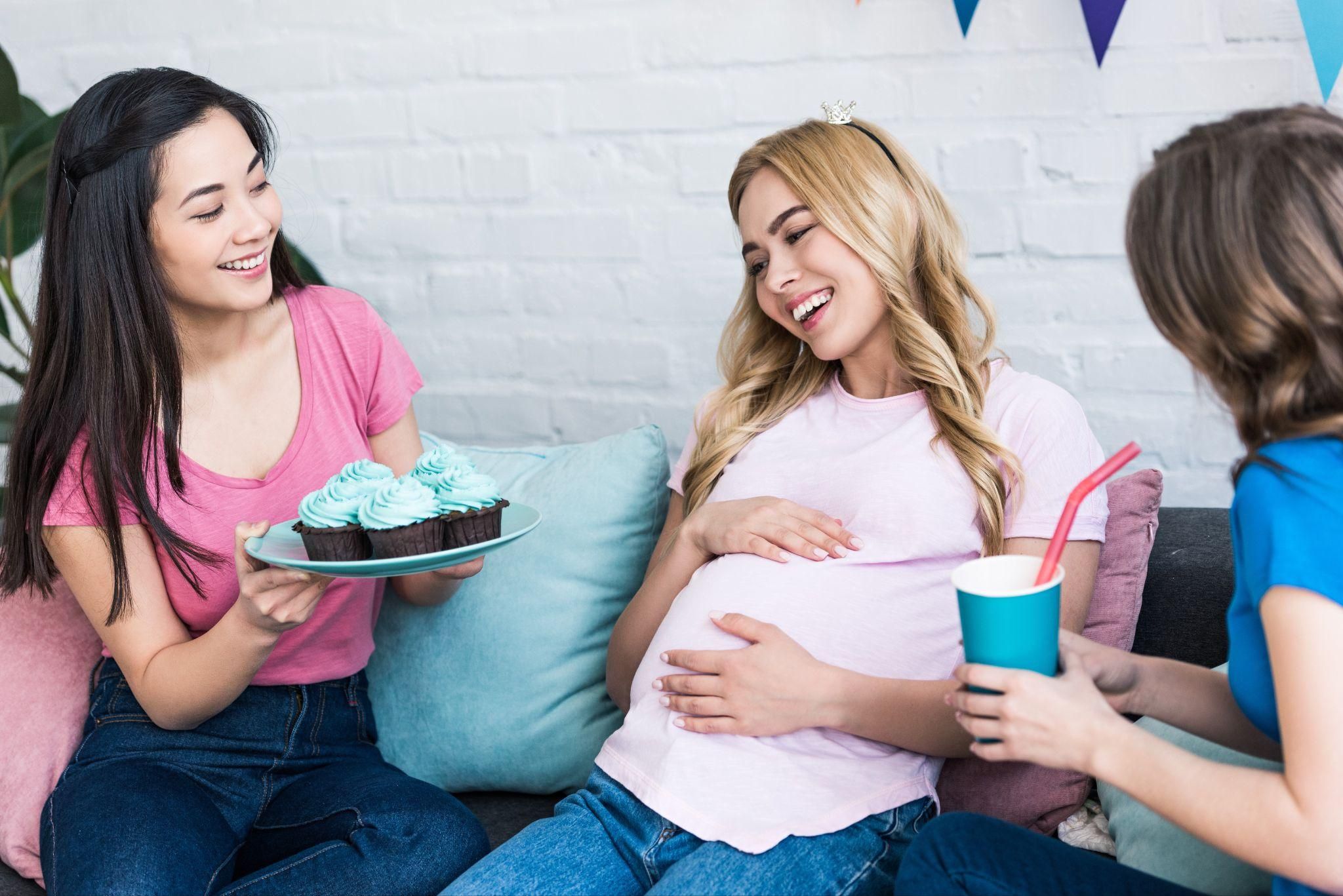 Baby shower guests exchanging simple, thoughtful gifts in a relaxed atmosphere.