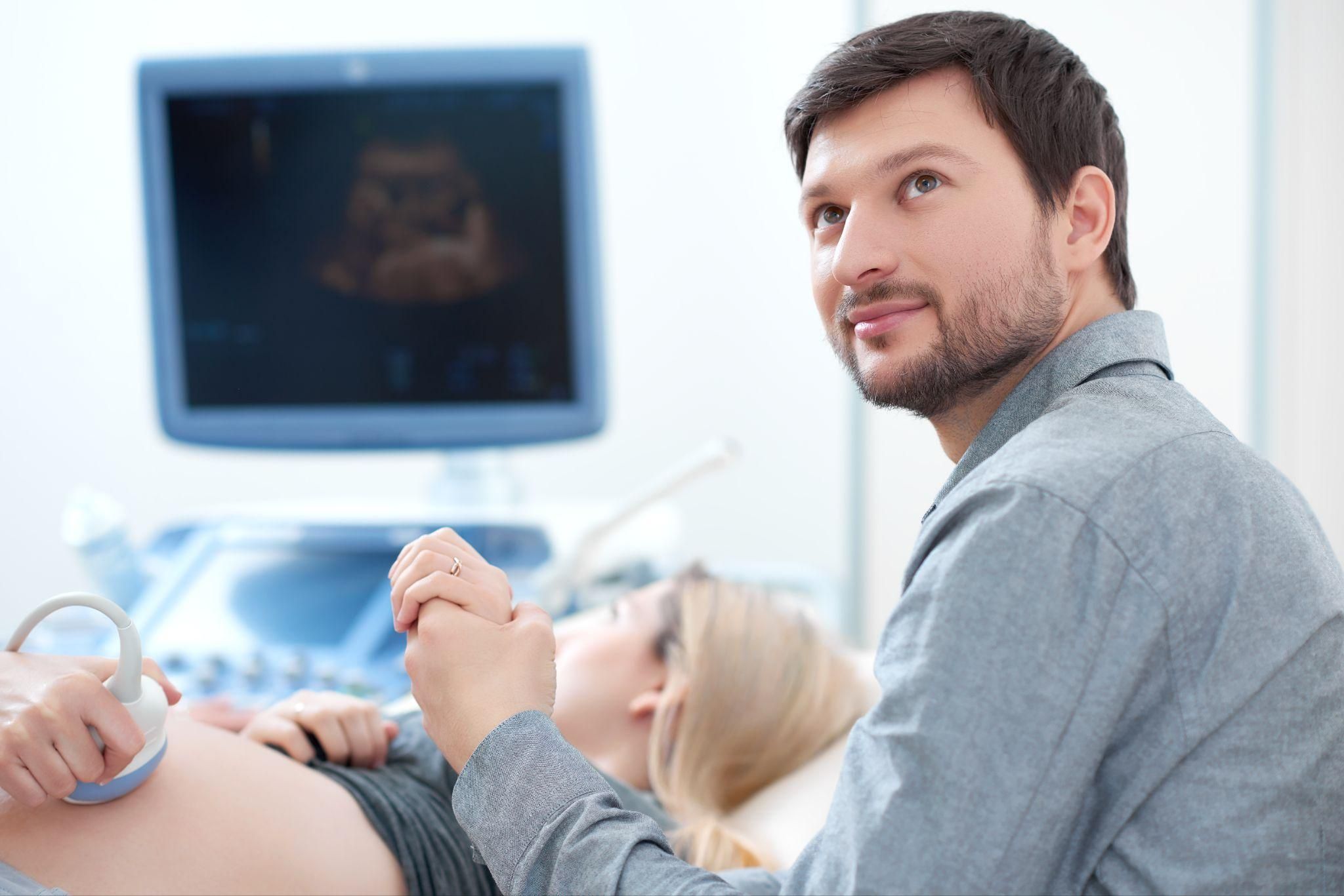 Unmarried father supporting the mother during an antenatal scan.