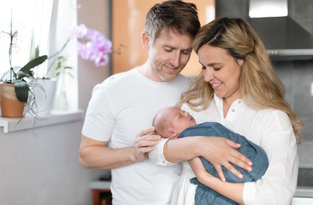 A loving partner offering emotional support to a new mother during the postpartum period.