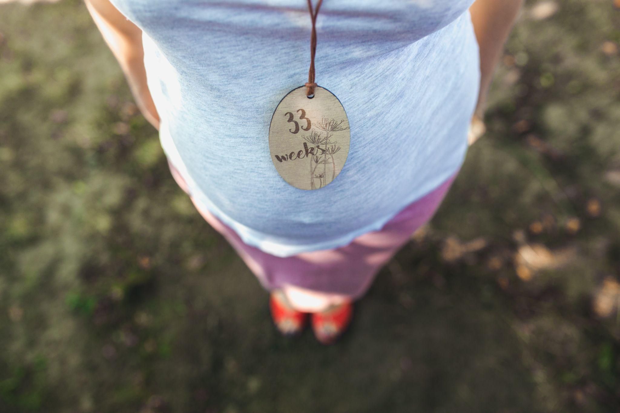 Pregnant woman practicing antenatal yoga at 33 weeks.