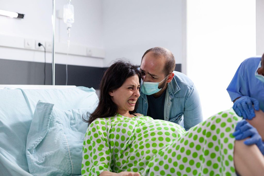 A couple attending antenatal classes, learning how to support each other during labour.