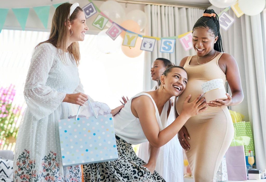 Guests enjoying a fun trivia game at a baby shower with colourful decorations.