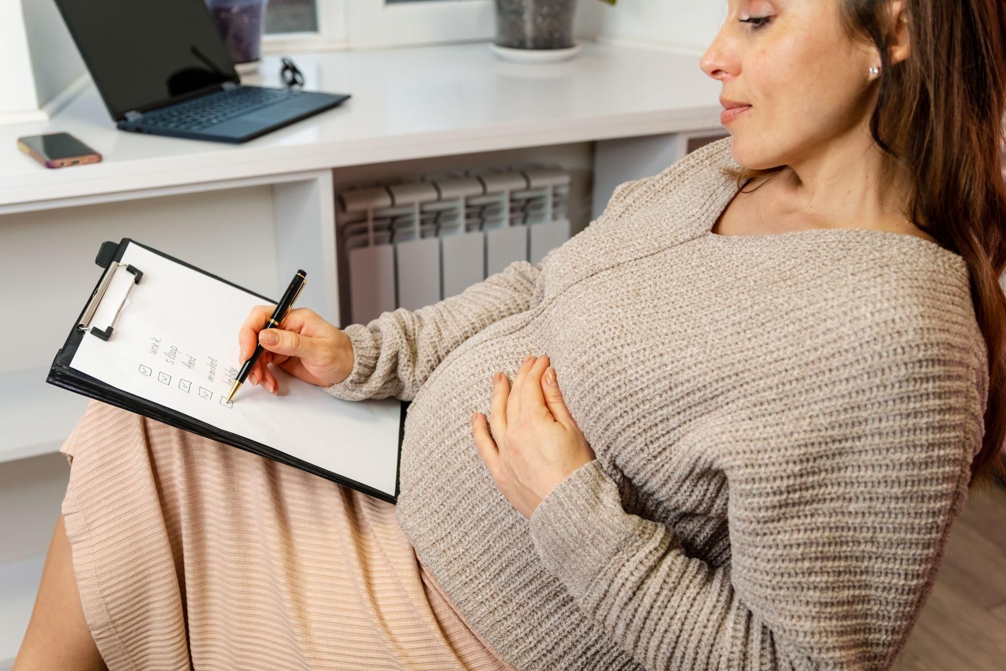 Midwife assisting expectant parent with birth plan.