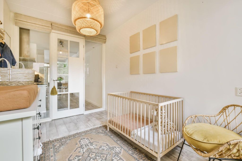 A trendy baby room with a gender-neutral colour palette, multifunctional furniture, and smart lighting.