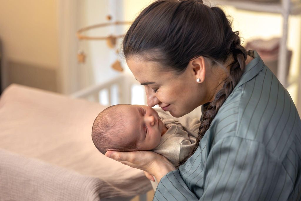 A new parent cradling their newborn during a quiet, soothing moment.