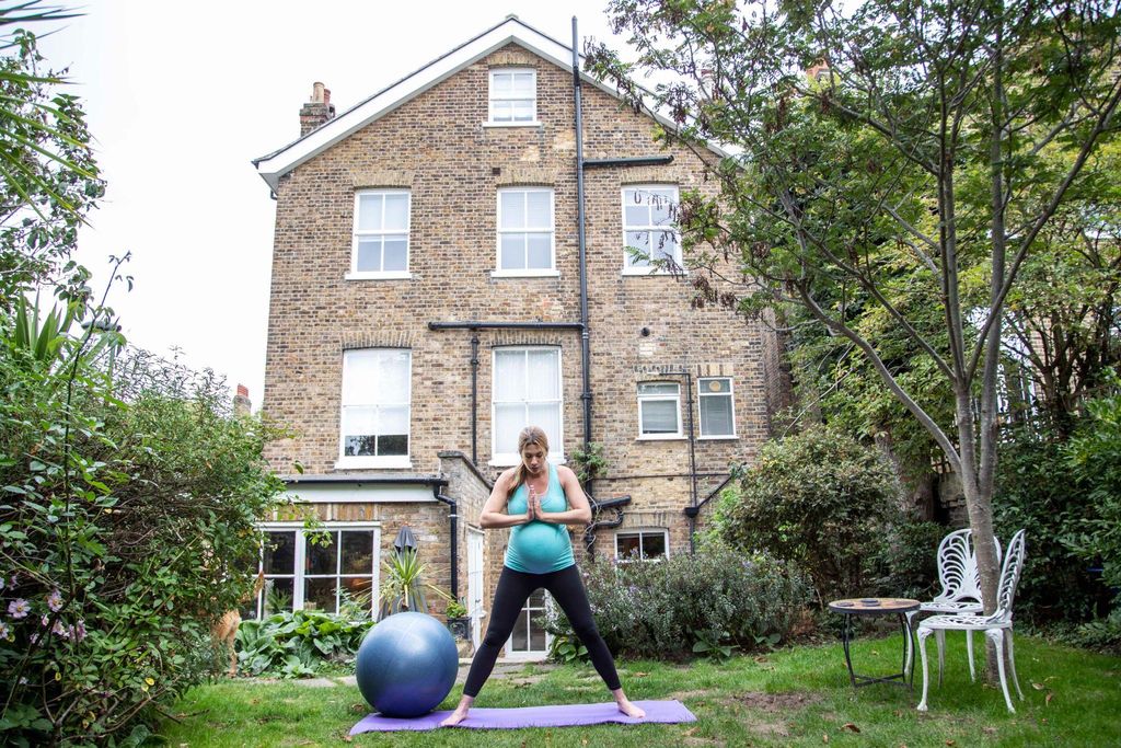 A pregnant woman attending an antenatal yoga class to prepare for labour.