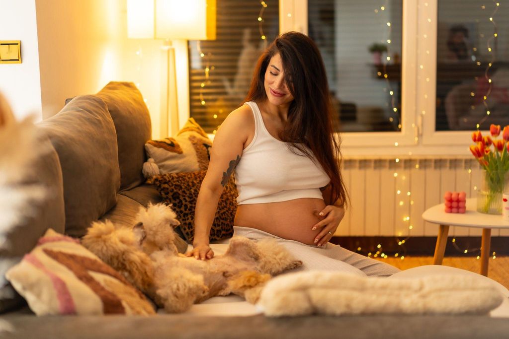 New mum cuddles her baby girl in the postnatal period at home.