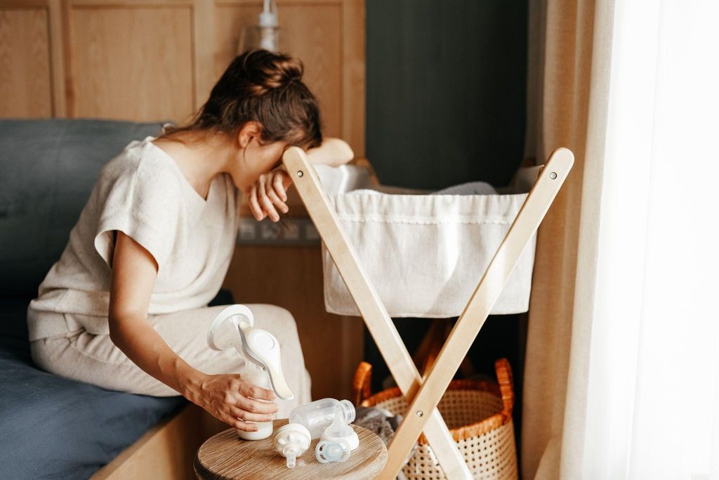 A mother undergoing a postpartum massage to aid in C-section recovery and alleviate anxiety.