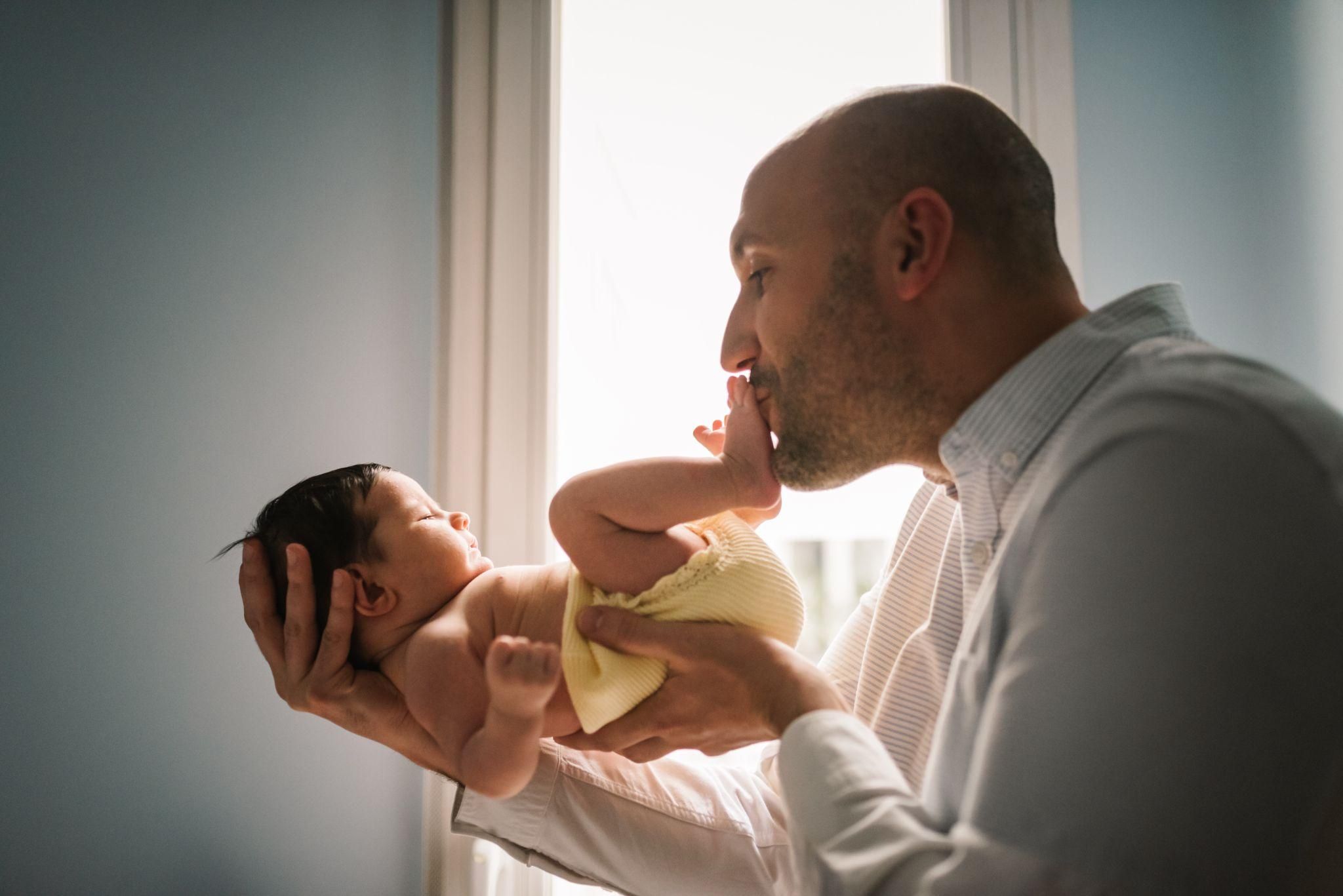 A new dad bonding with his baby during paternity leave.