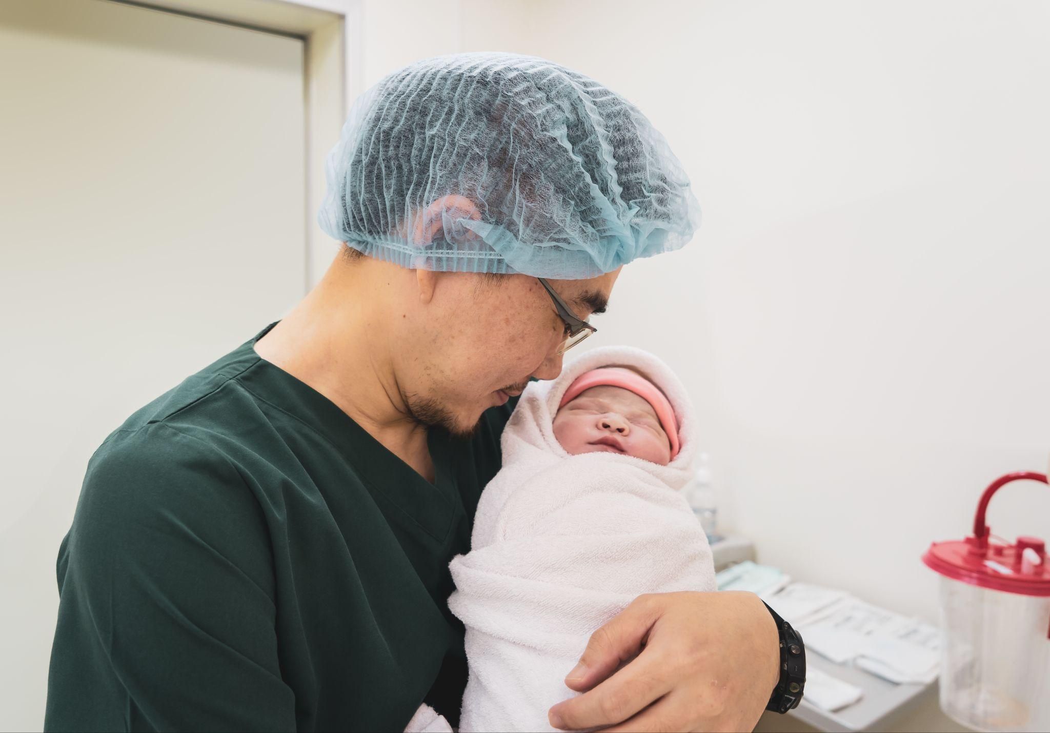 A pregnant woman and her partner learning about C-section delivery through a video.