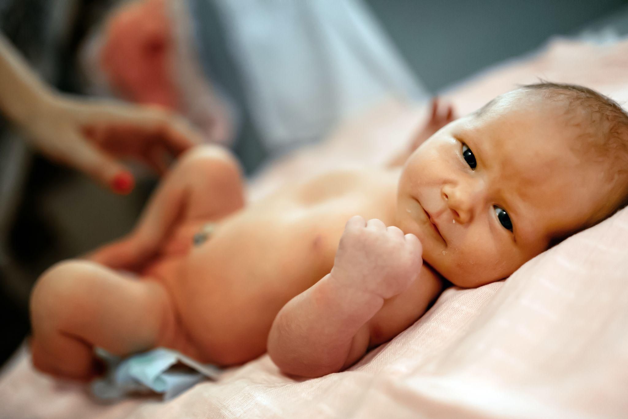 A premature baby receiving kangaroo care with skin-to-skin contact.