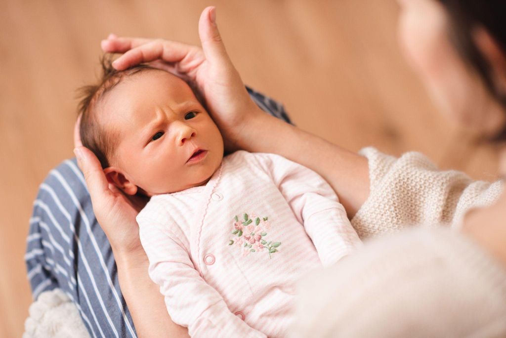 A mother practicing skin-to-skin contact with her newborn baby to support the development of a healthy microbiome after birth.