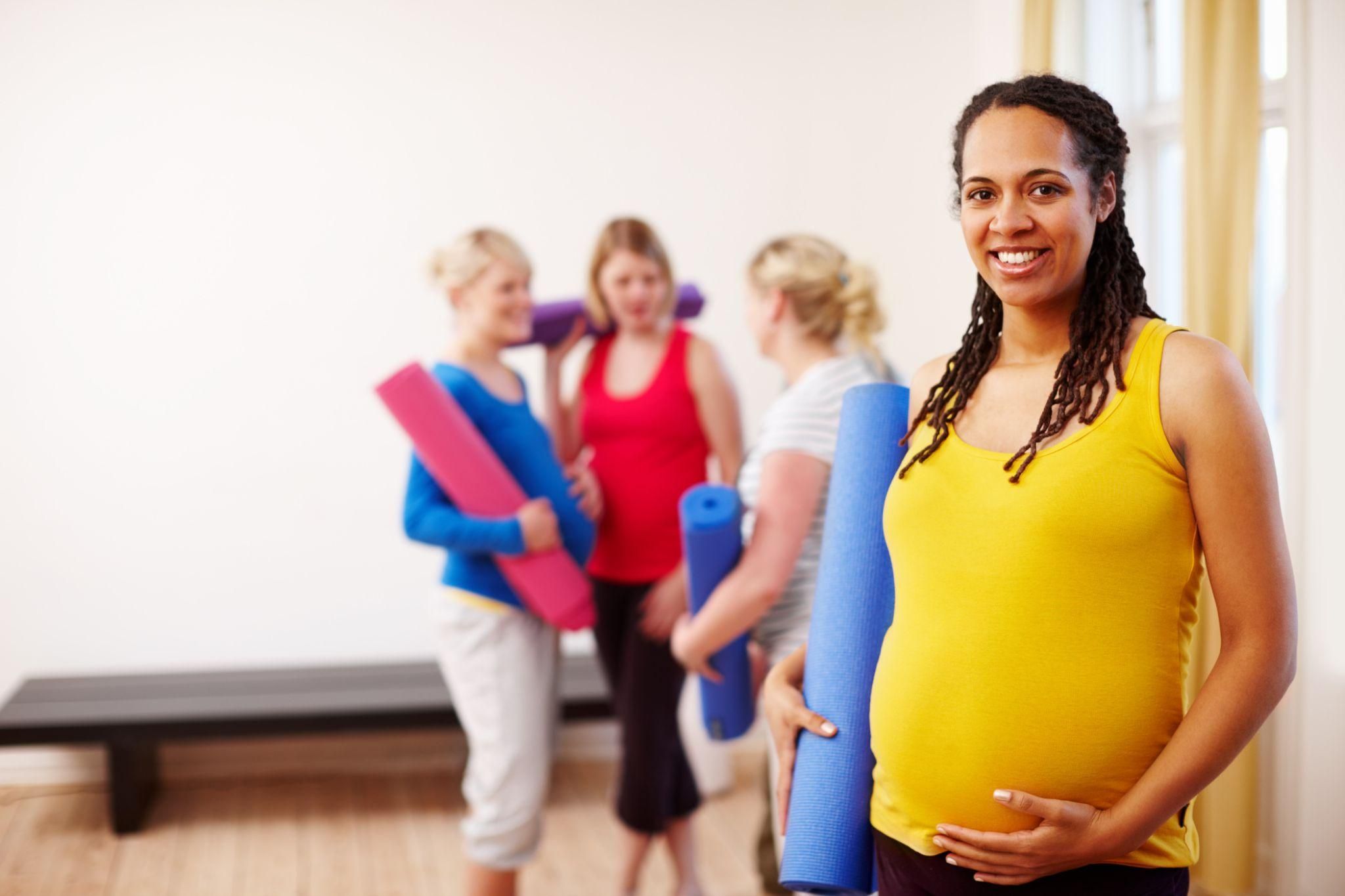 A midwife explaining pain relief options to a pregnant woman during an antenatal appointment in a London hospital.