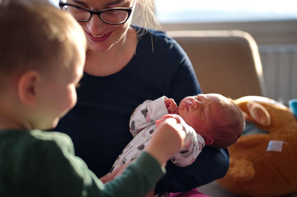 An expectant mother considering home birth vs hospital birth while consulting with her midwife.